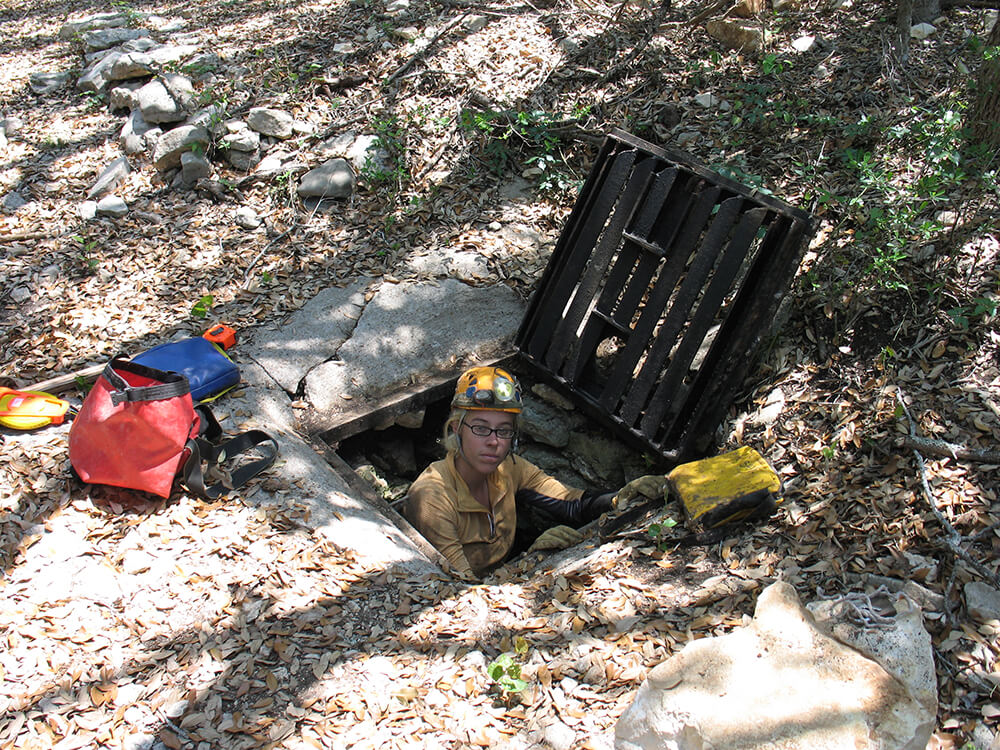 A volunteer helping to keep caves clean from sewer waste.