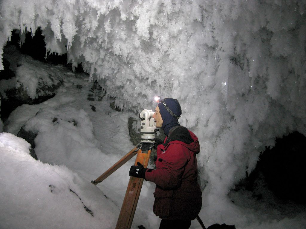 Aaron Curtis, from NCKRI and a New Mexico Tech student, is seen here giving the first systematic survey of ice caves on Mount Erebus.