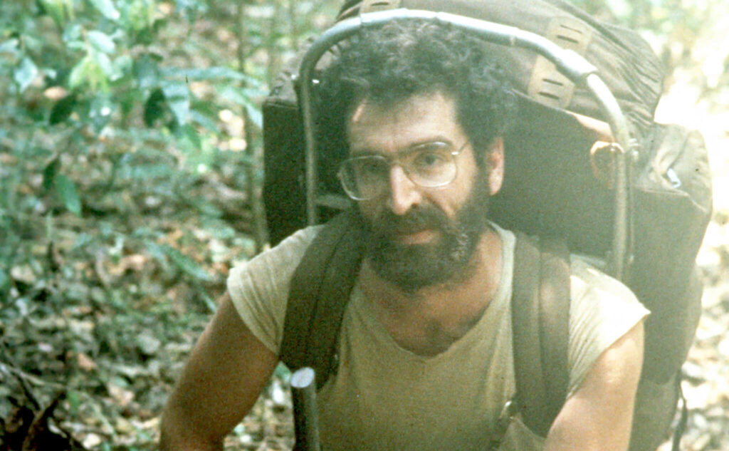 A young Dr. George Veni backpacking to a cave