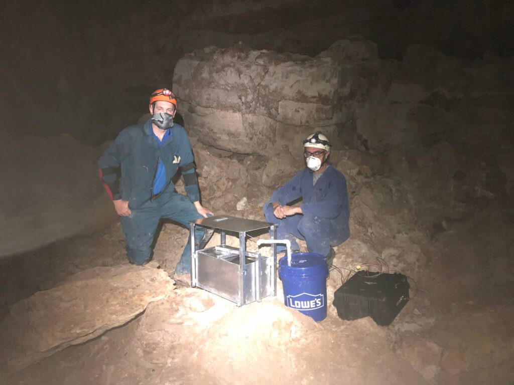 NCKRI crew members building a pan evaporimeter to record continuos data that estimates evaporation rates in high humidity caves like this one.